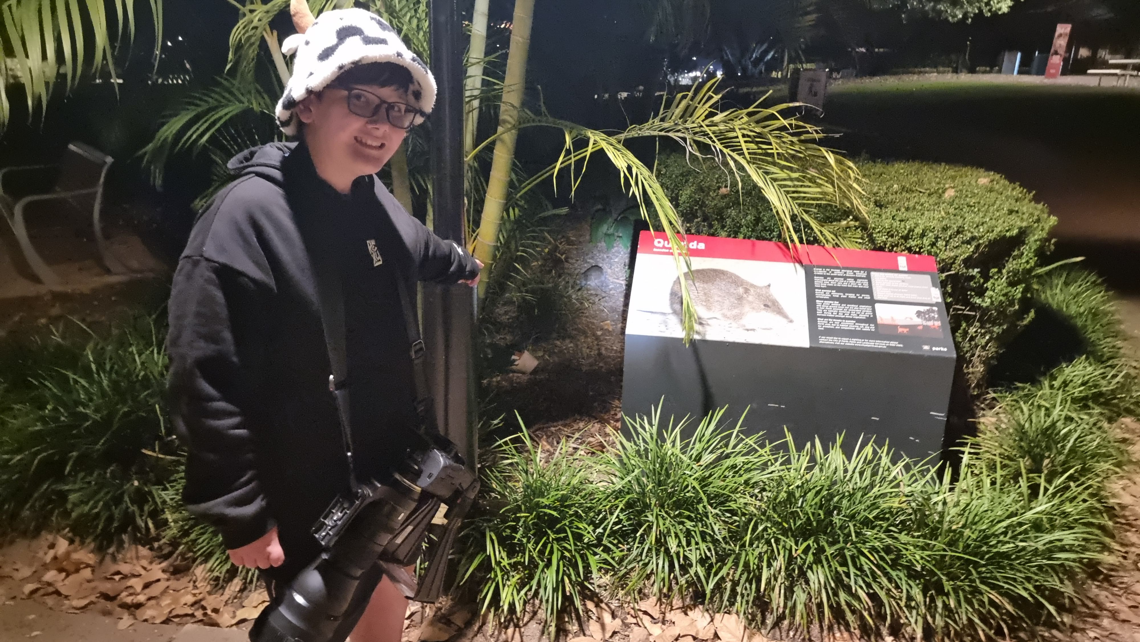 Liam by the Quenda sign